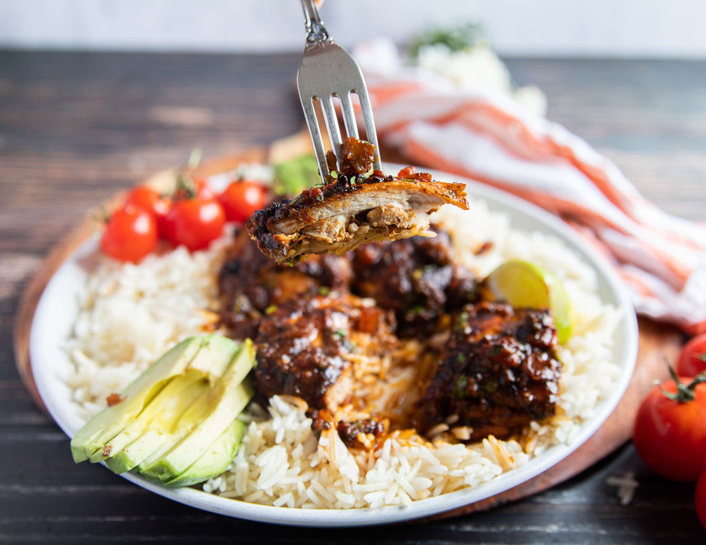 Sealand Mexican chicken thighs served with rice fresh limes avocado and tomatoes