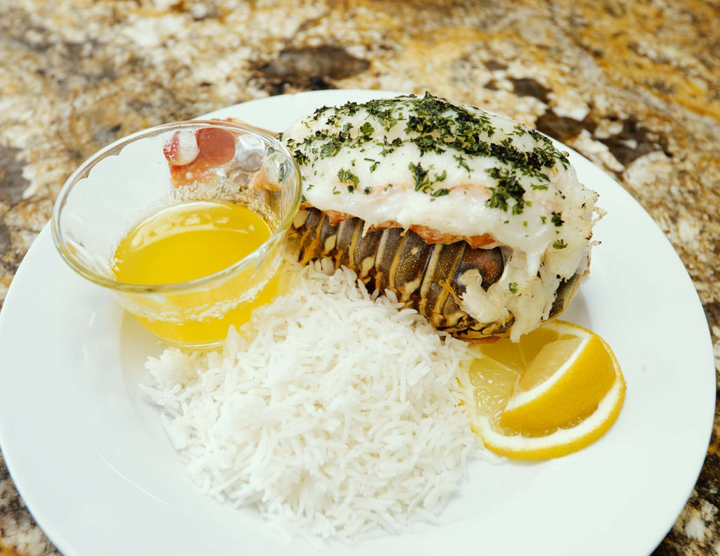 Sealand broiled warm water lobster tail with rice, fresh lemon and butter dip