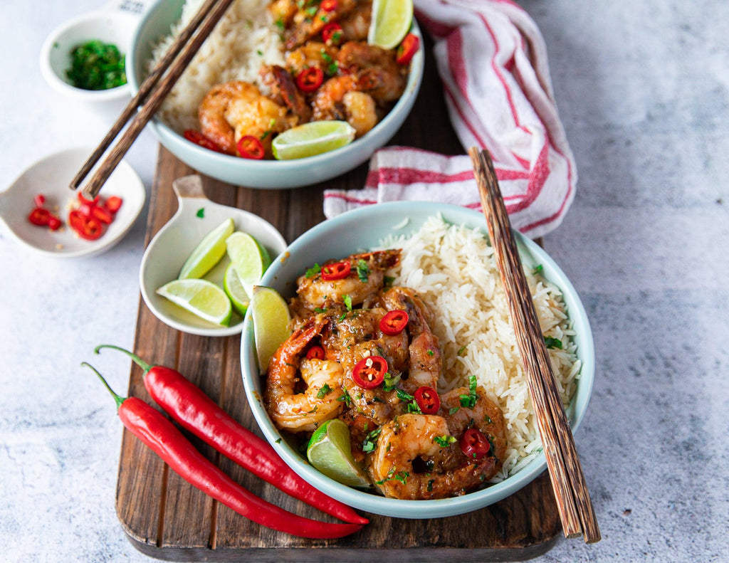 Sealand chili lime shrimp in bowls with rice, fresh limes and chili