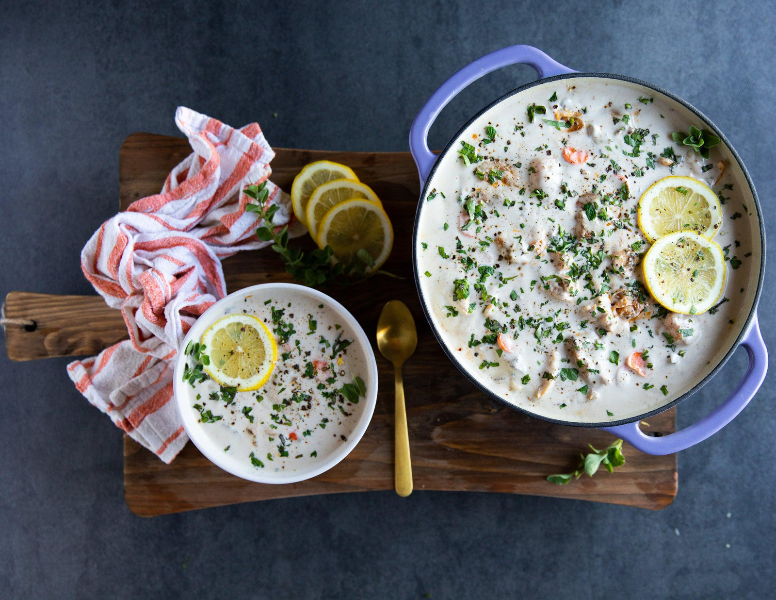 Creamy seafood chowder with garnish and fresh lemon slices