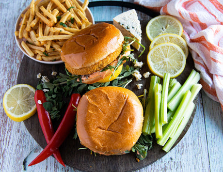 Buffalo chicken burgers with fries, red chilis, blue cheese and celery