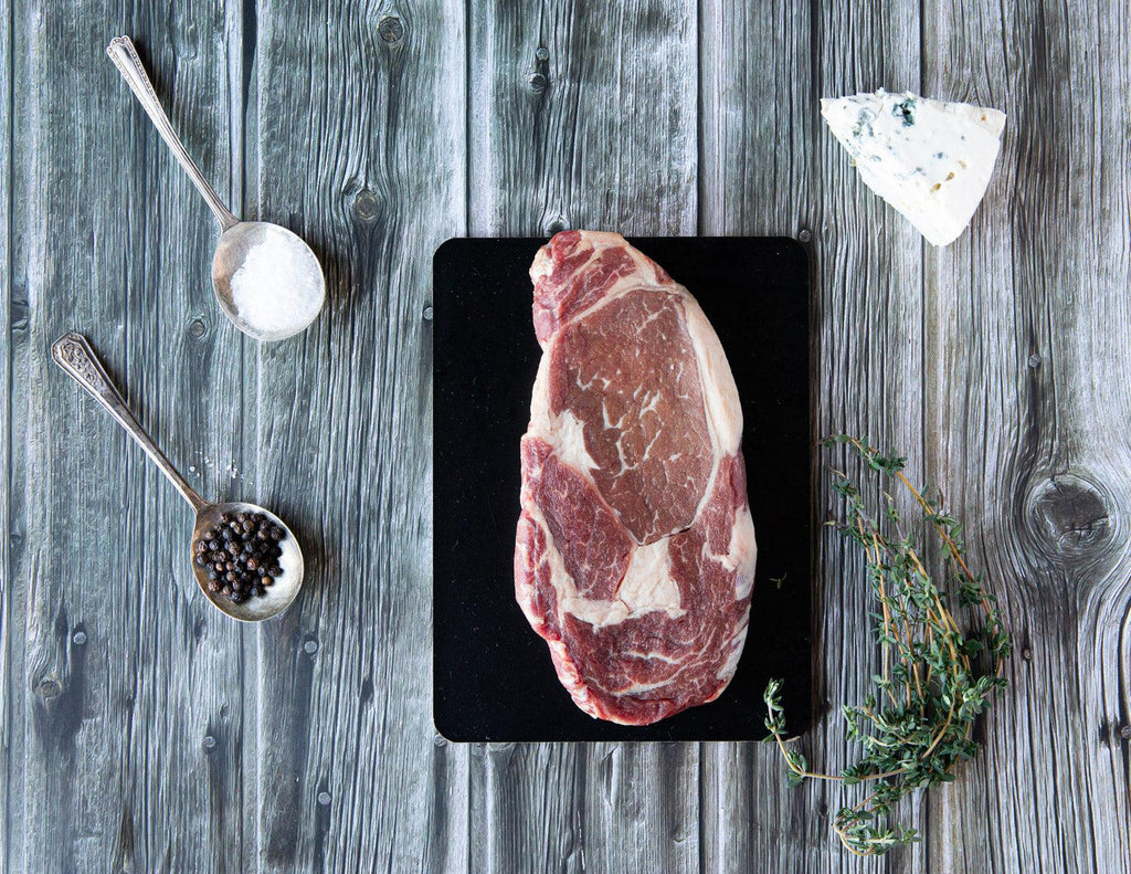 A raw 12oz Ribeye Steak from Sealand Quality Foods.