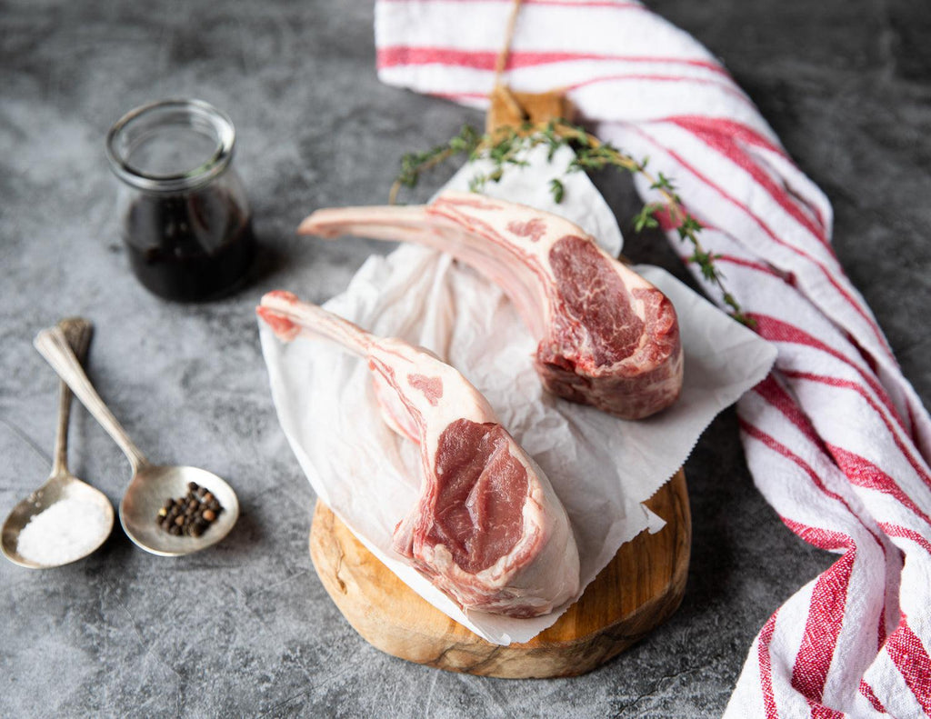 Raw 2 Bone French Racks of Lamb on Parchment Paper