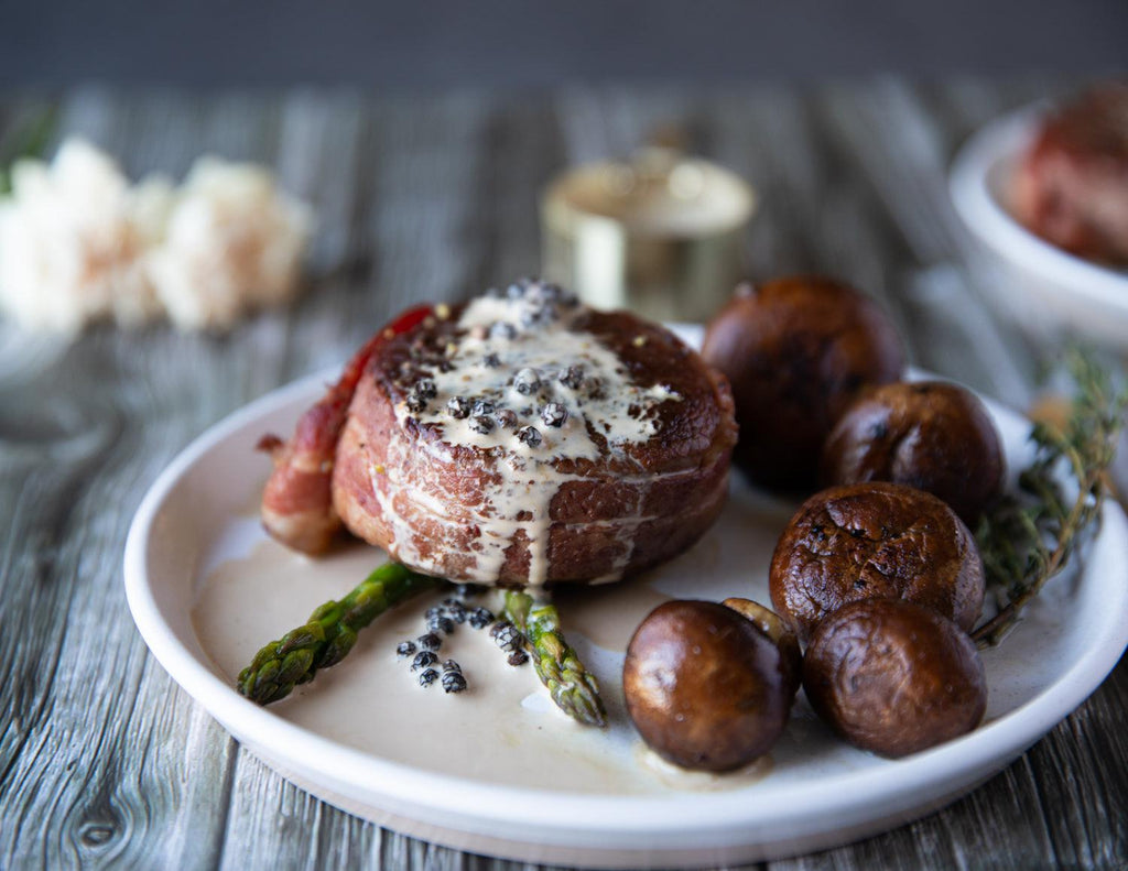 Sealand's 6oz Bacon Wrapped Tenderloin Steaks with fresh asparagus and mushrooms.