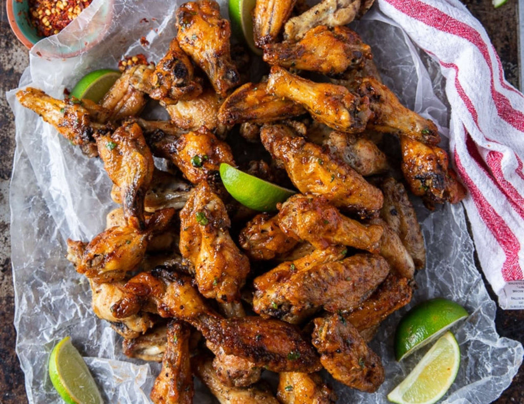 Platter of Air Fryer Chicken Wings Sauced and Served with Limes