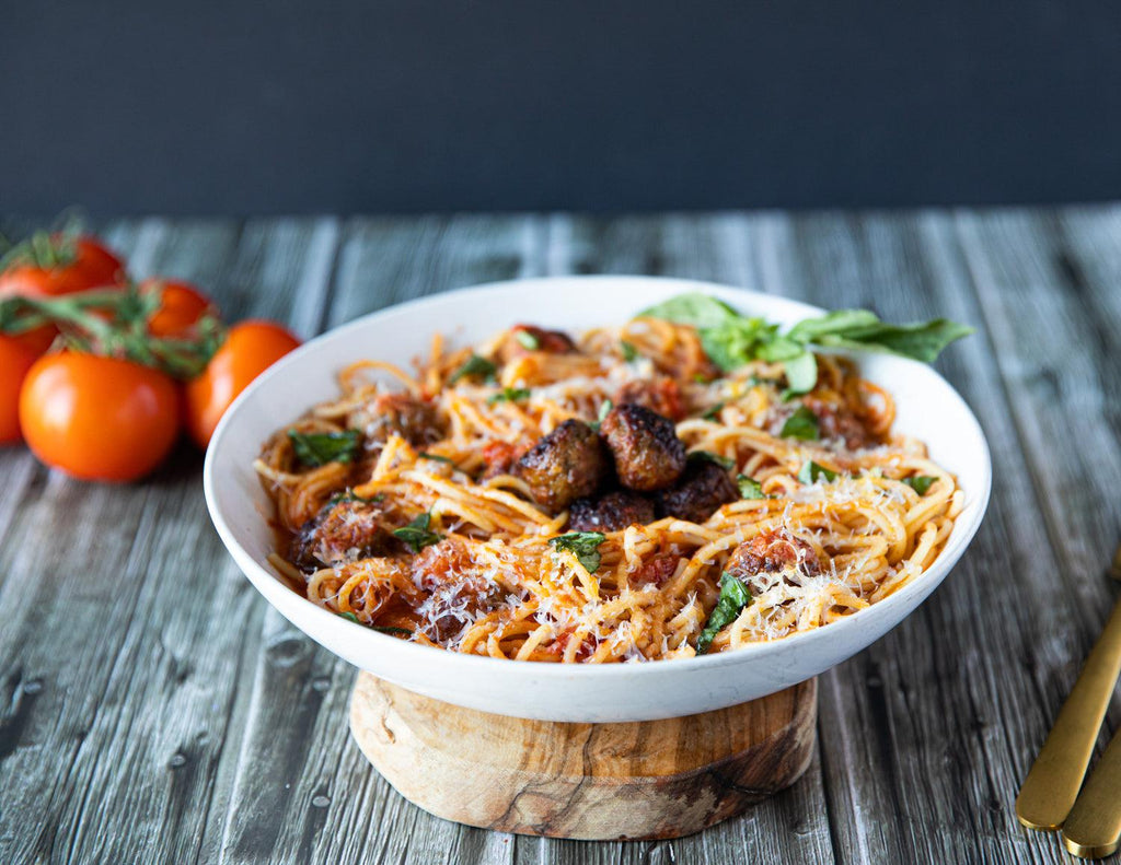Sealand Quality Foods' Beef Meatballs on a bed of spaghetti with parmesan and basil.