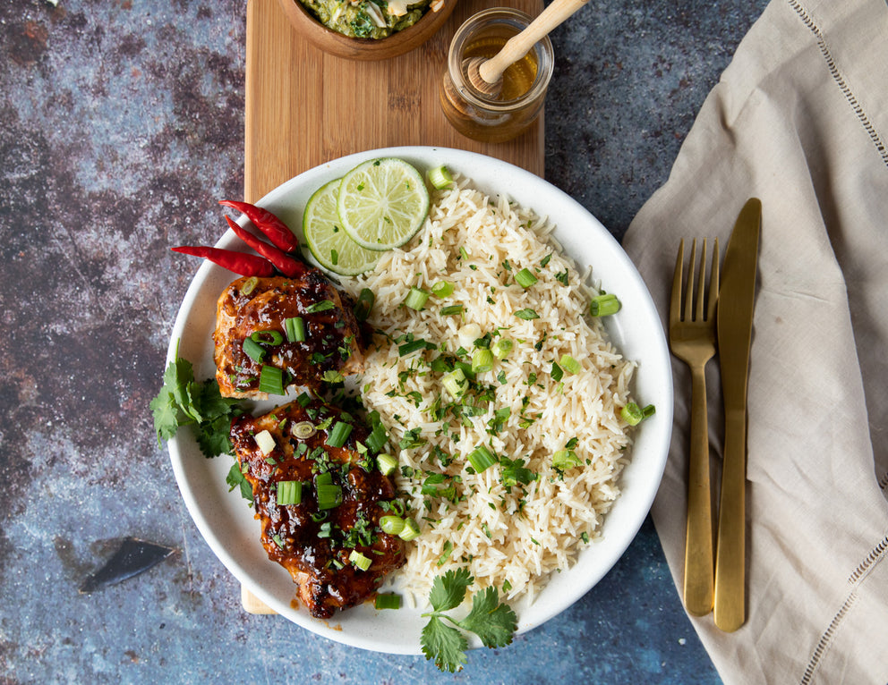 Sealand Quality Foods Boneless Pork Steaks on a Plate with Rice and Green Onions