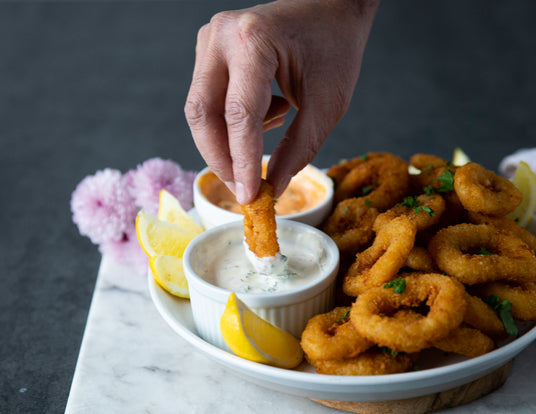 Dipping a Sealand Breaded Calamari Ring into Homemade Tartar Sauce