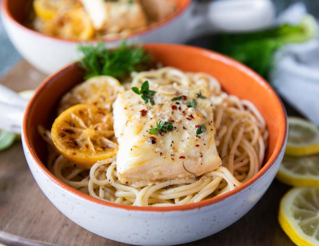 Bowl of Buttered Baked Halibut Over Pasta