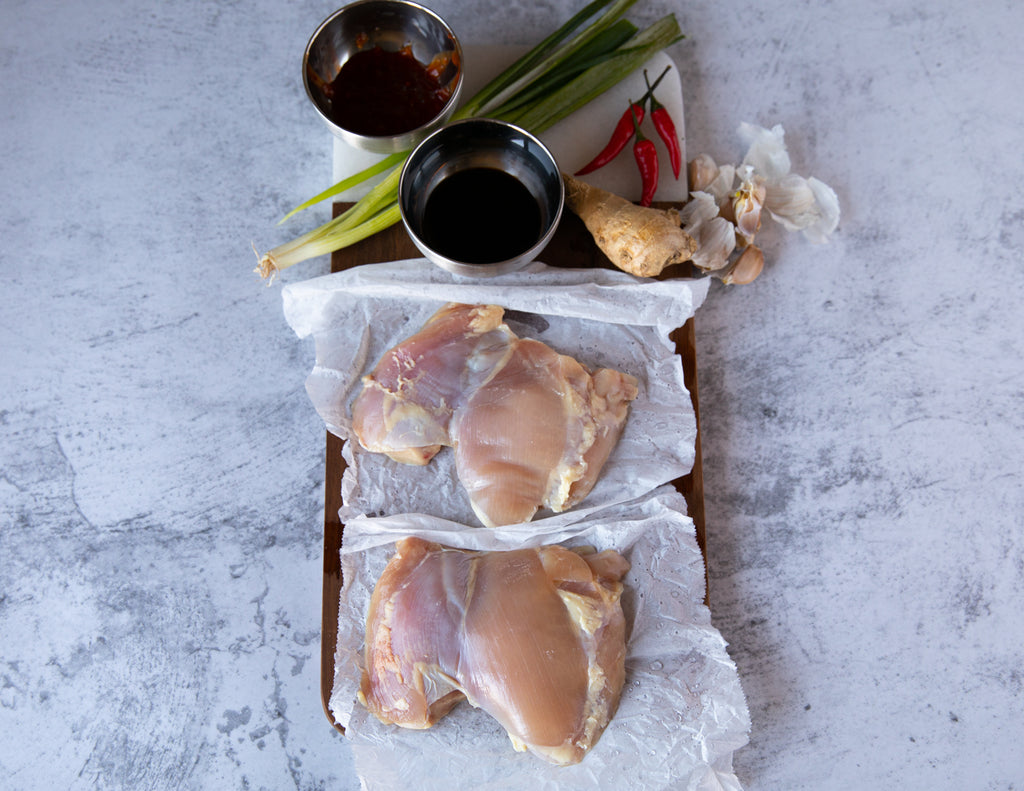 Raw Sealand Quality Foods Chicken Thighs on Parchment Paper