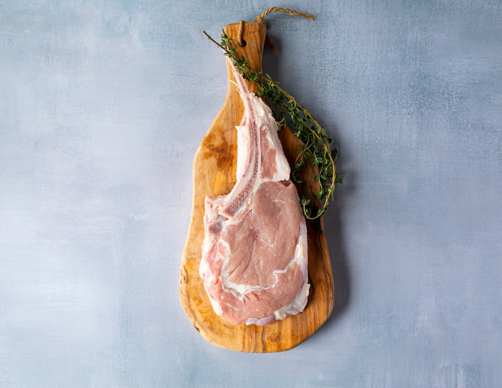 Sealand Quality Foods Raw French Cut Veal Chop on a Cutting Board