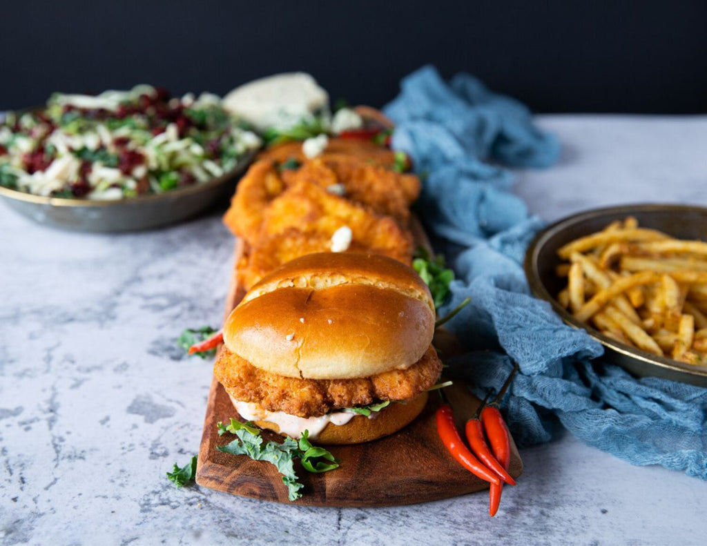 Sealand Quality Foods Gluten-Free Breaded Chicken Burgers with chili peppers, fries and coleslaw