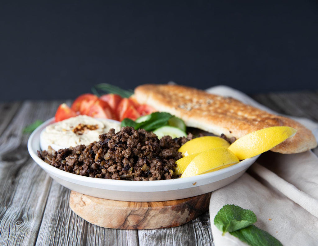 Sealand Quality Foods' cooked Ground Beef with hummus, fresh vegetables and a baguette.