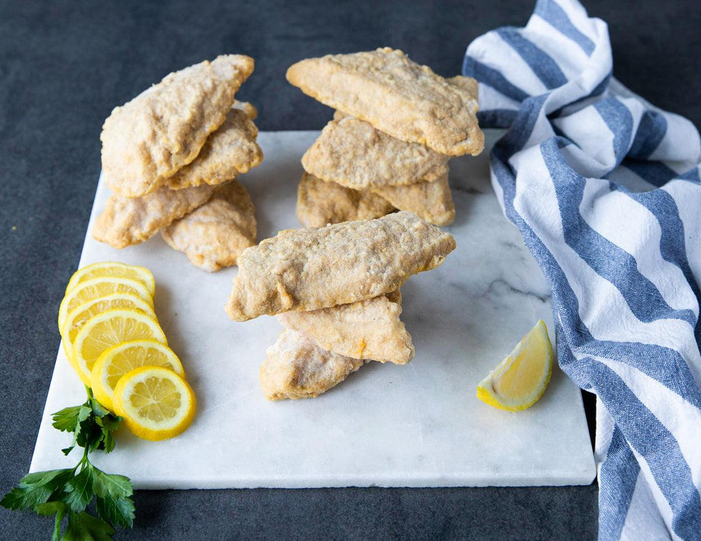Stacked raw Guinness Battered Cod from Sealand Quality Foods.