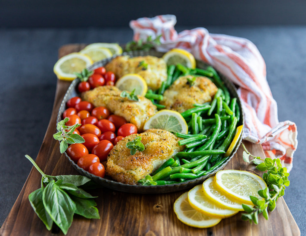 Sealand's Herb Crusted Cod Fillets served on a platter with green beans and tomatoes.