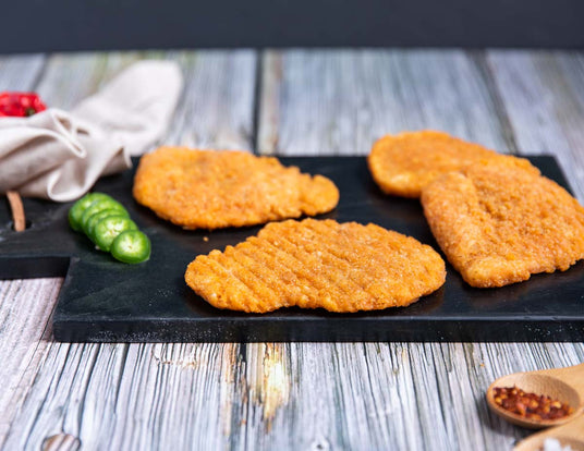 Plate of Hot and Spicy Chicken Breast Burgers Ready to Cook