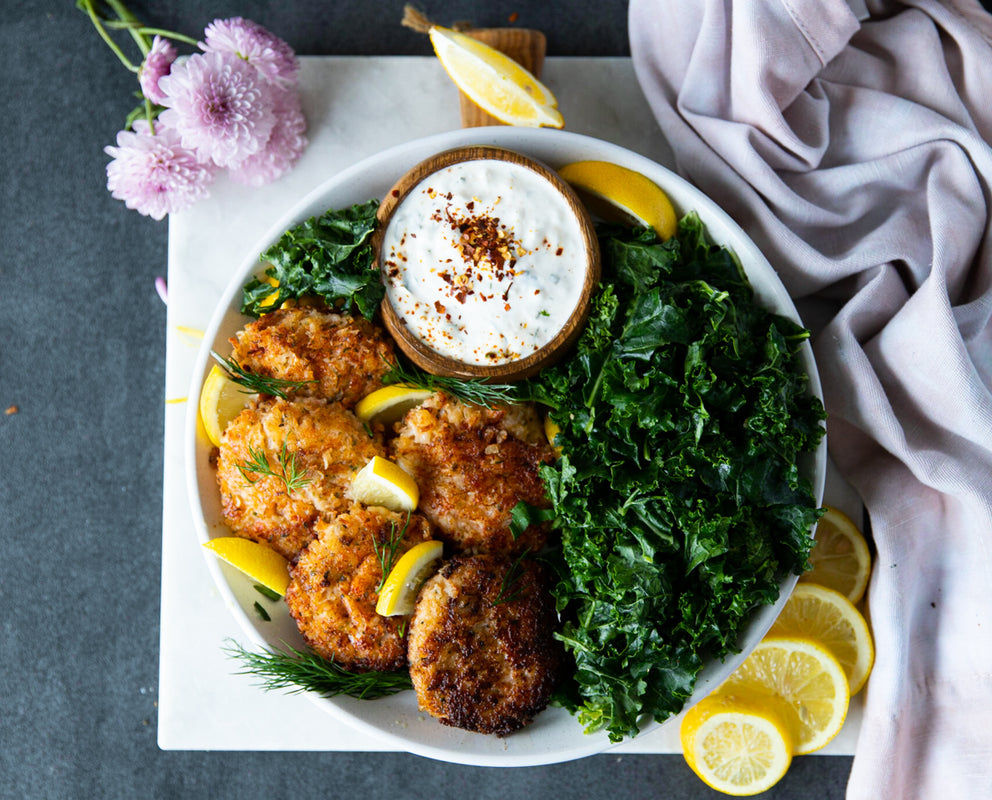 Cooked Lobster Seafood Cakes by Sealand Quality Foods Plated with Kale and Lemon