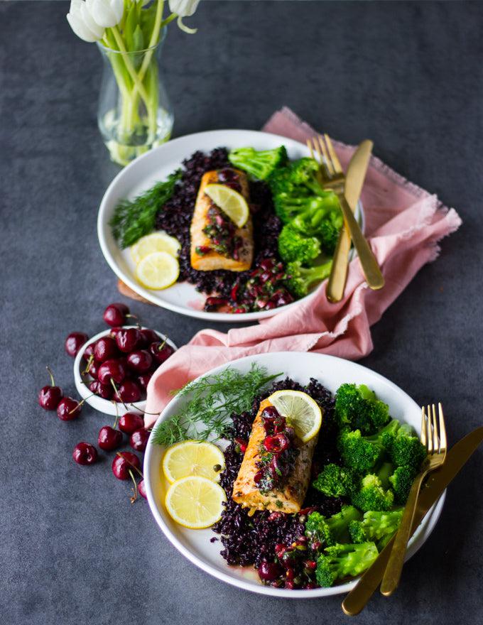 Sealand's Mahi Mahi Fillets plated on a bed of cranberry sauce with a side of steamed broccoli.