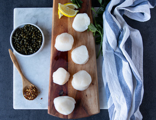 Sealand Large Natural Dry Scallops Sitting Raw on a Cutting Board