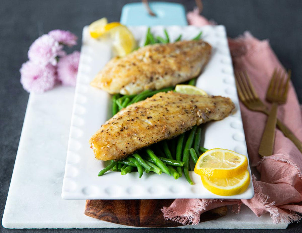 Sealand Quality Foods' Red Snapper Fillets served on a bed of green beans.