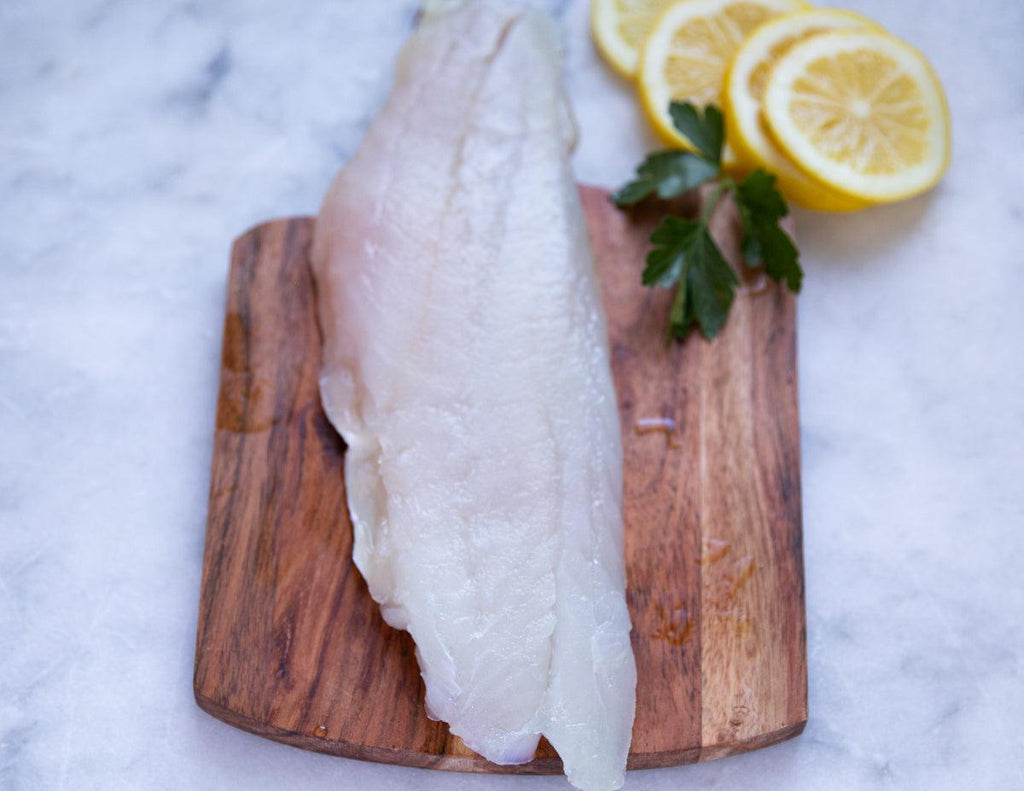 Sealand Quality Foods' raw Red Snapper Fillet on a cedar plank.