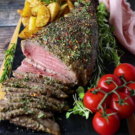 Sealand Quality Foods mustard and herb top sirloin roast sliced with potato wedges and vine tomatoes 