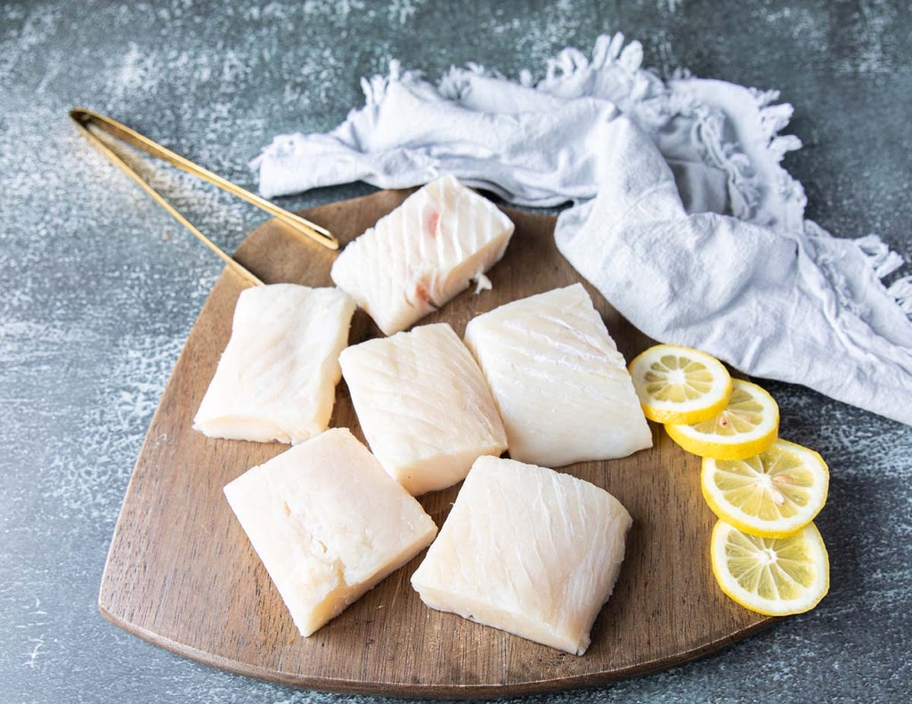 Cutting Board with Raw Halibut Fillets from Sealand Quality Foods