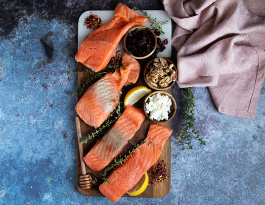 Cutting Board with Raw Skinless Centre Cut Norwegian Steelhead Salmon from Sealand Quality Foods