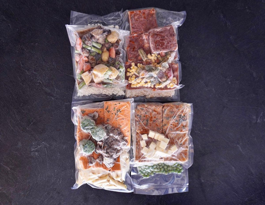 All four Vegetarian Ready in Minutes Meal Kits frozen in vacuum-sealed packaging.