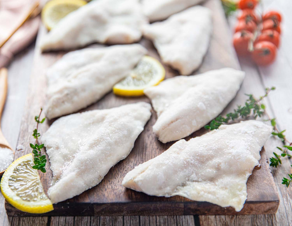 Up close shot of Sealand's Wild Caught Ontario White Perch Fillets frozen and placed on a wooden plank.
